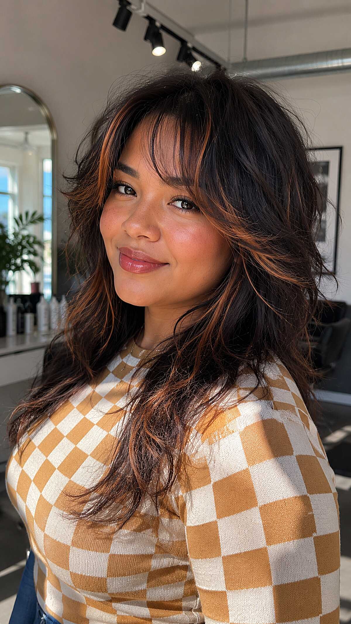 Dark shaggy wolf cut with copper highlights and bangs