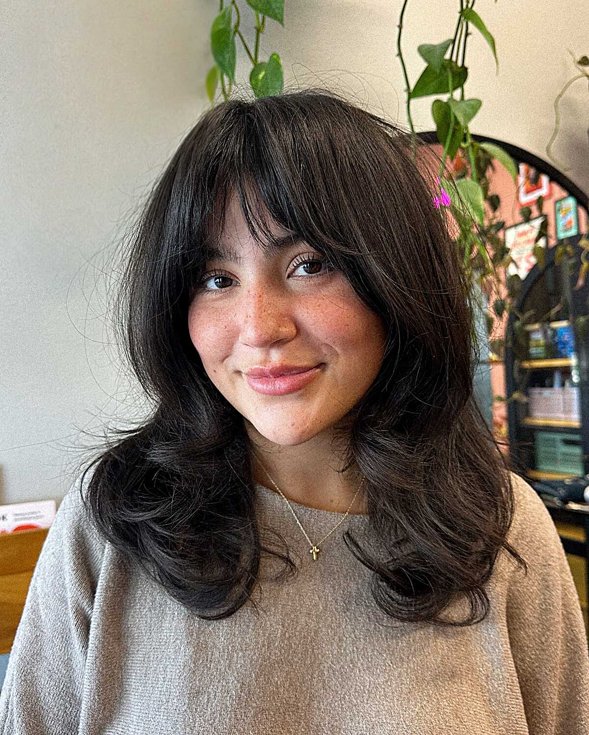 Dark brown blowout with full bangs and wavy ends