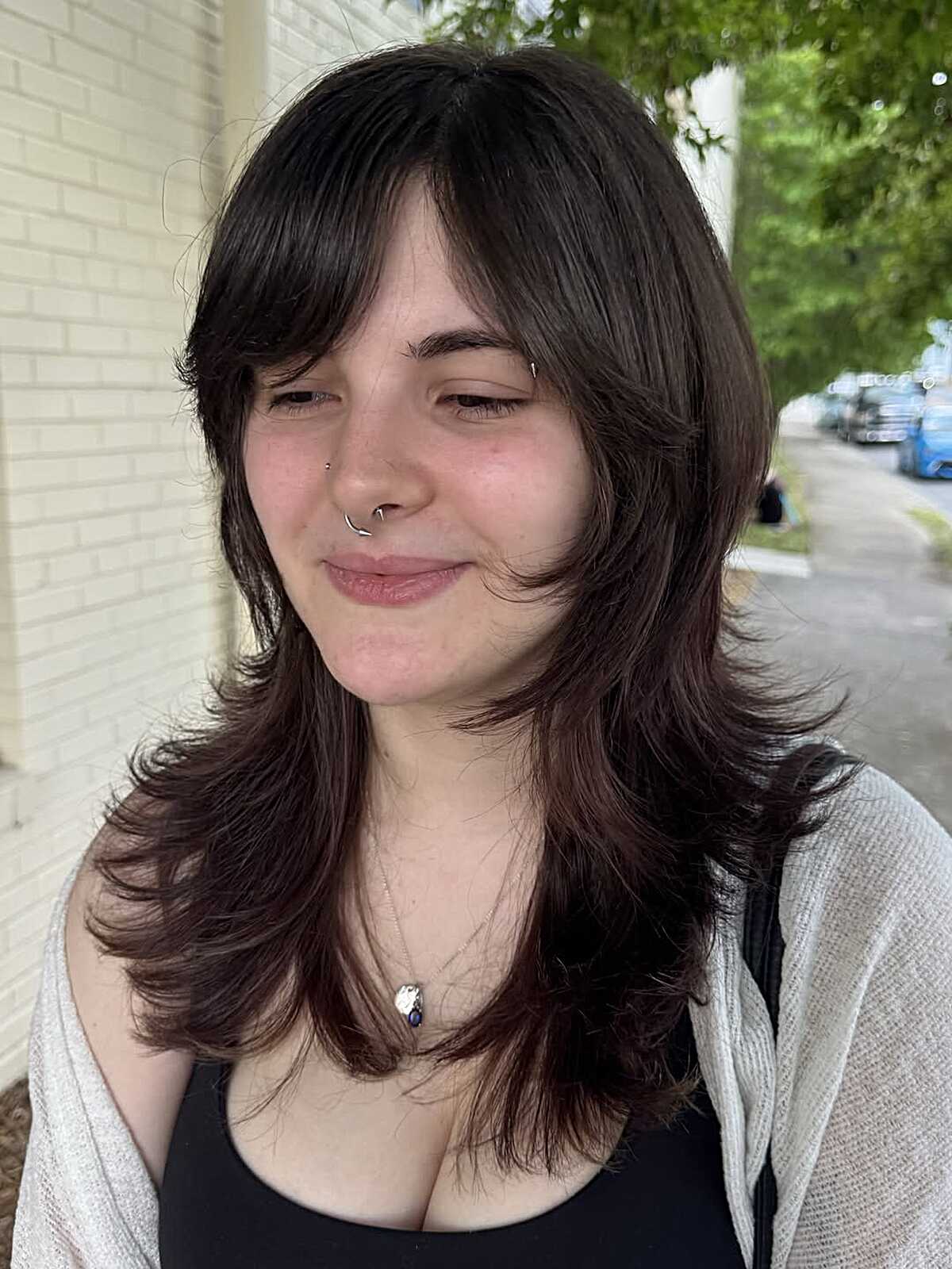 Medium dark brown wolf cut with textured side-swept bangs