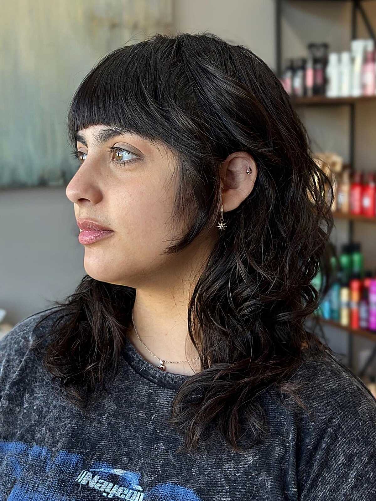 Black wavy mid-length shag with short straight bangs