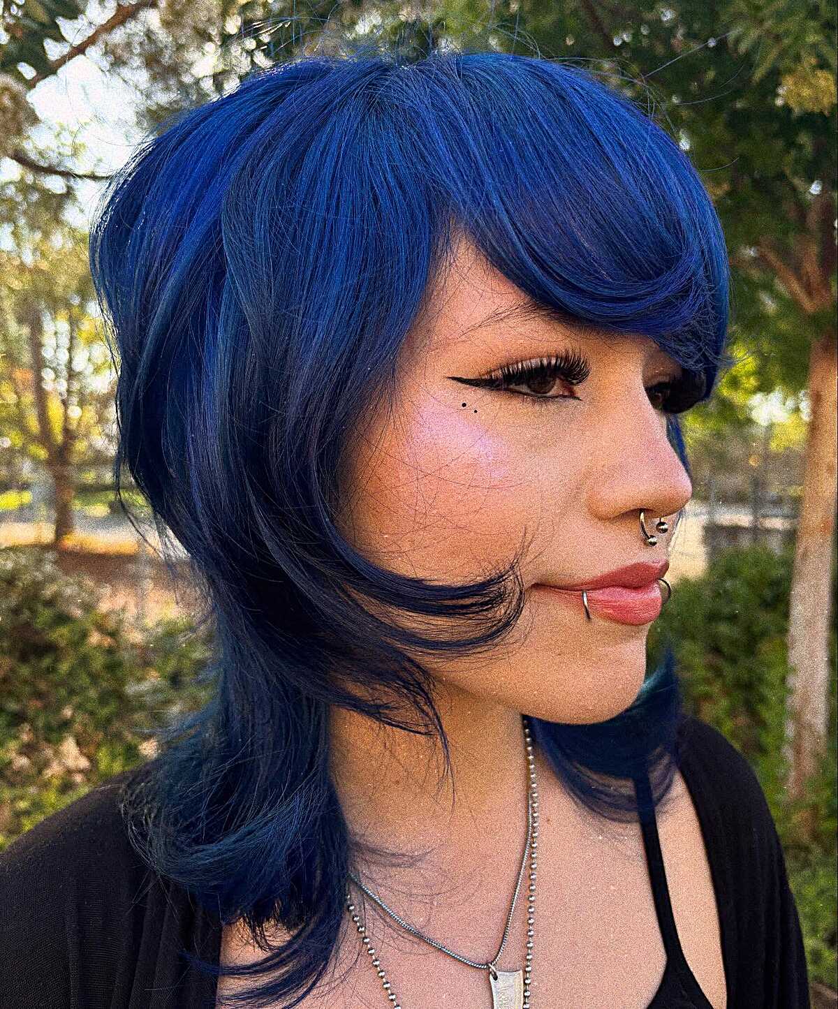 Deep blue shag with sculpted side-swept bangs and volume