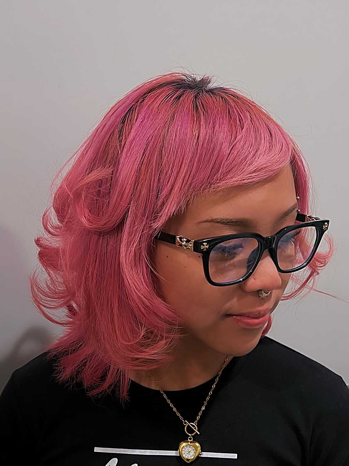 Dusty pink chin-length bob with dark roots and side bangs