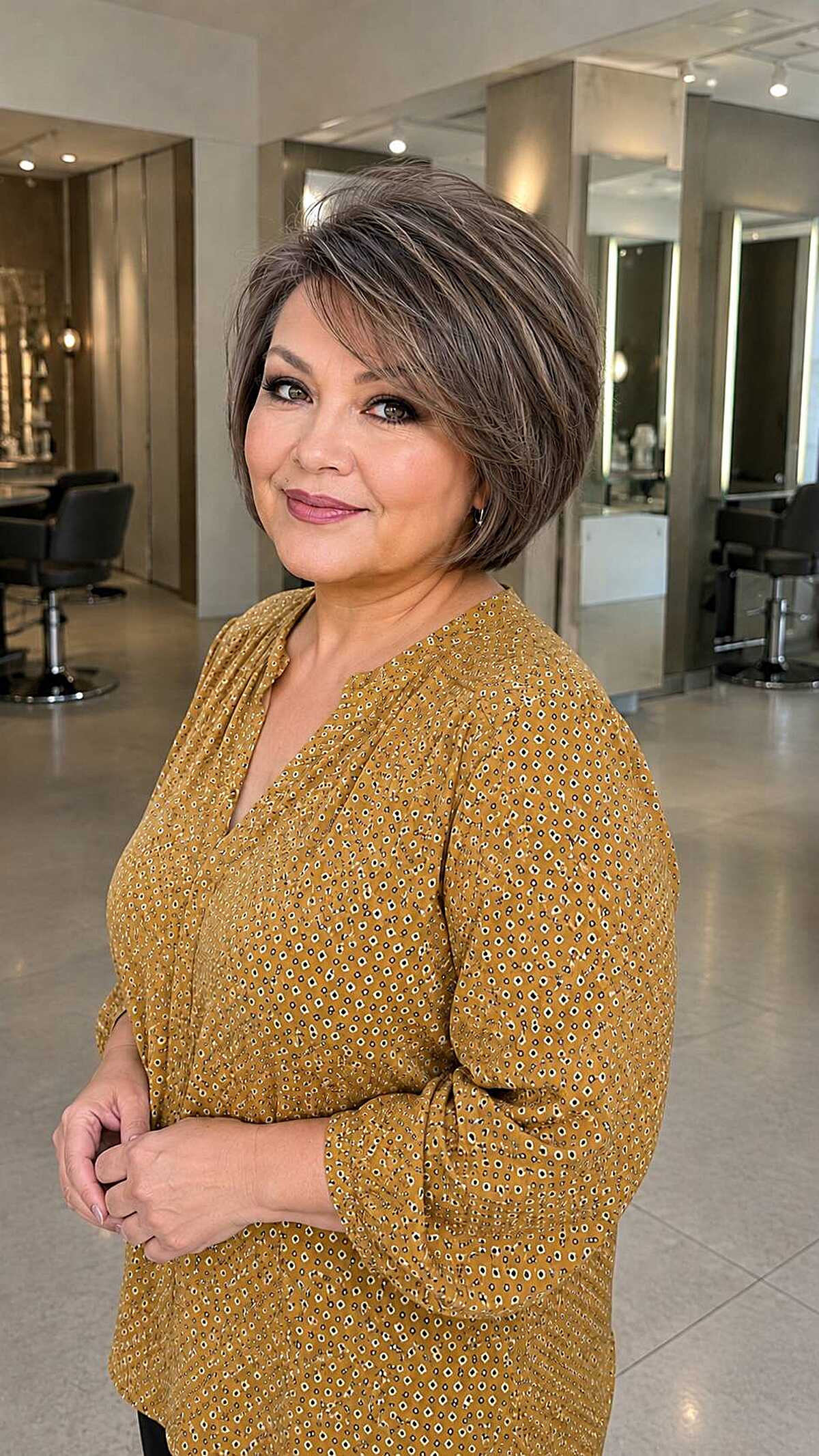 Sleek chin-length brunette bob with subtle silver streaks
