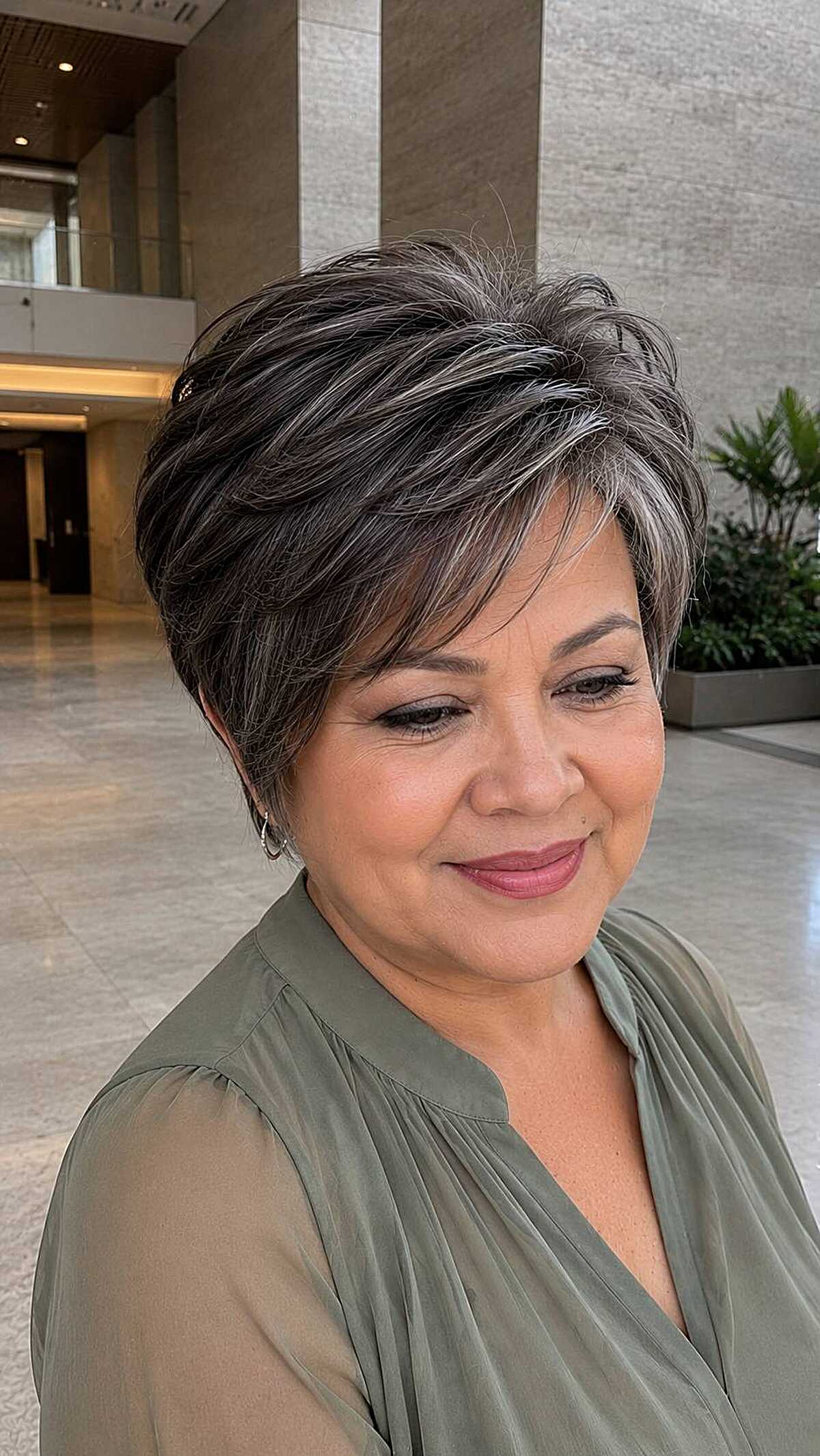 Dark salt-and-pepper pixie with textured forward sweep