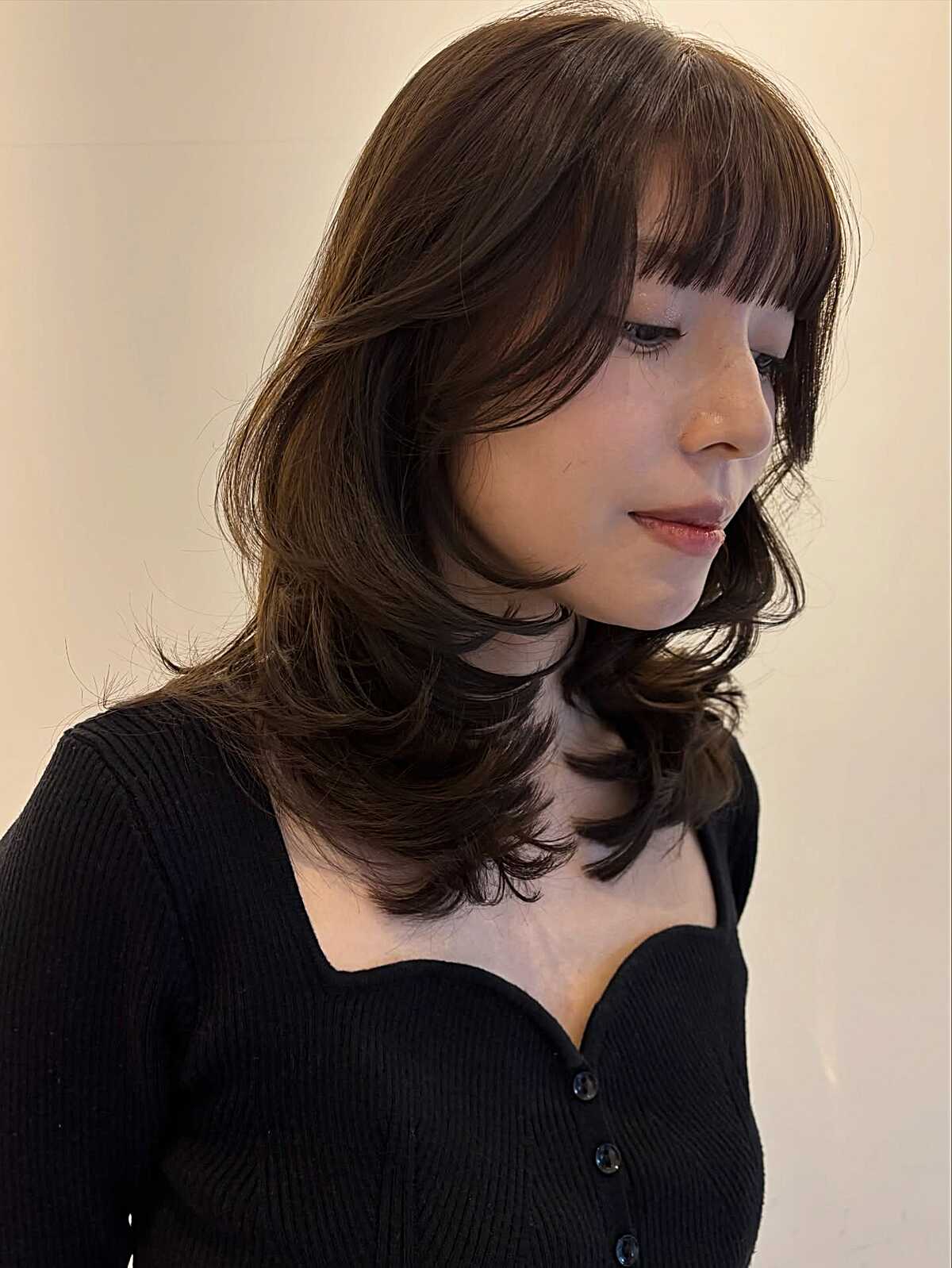 Brown layered mid-length bob with straight bangs