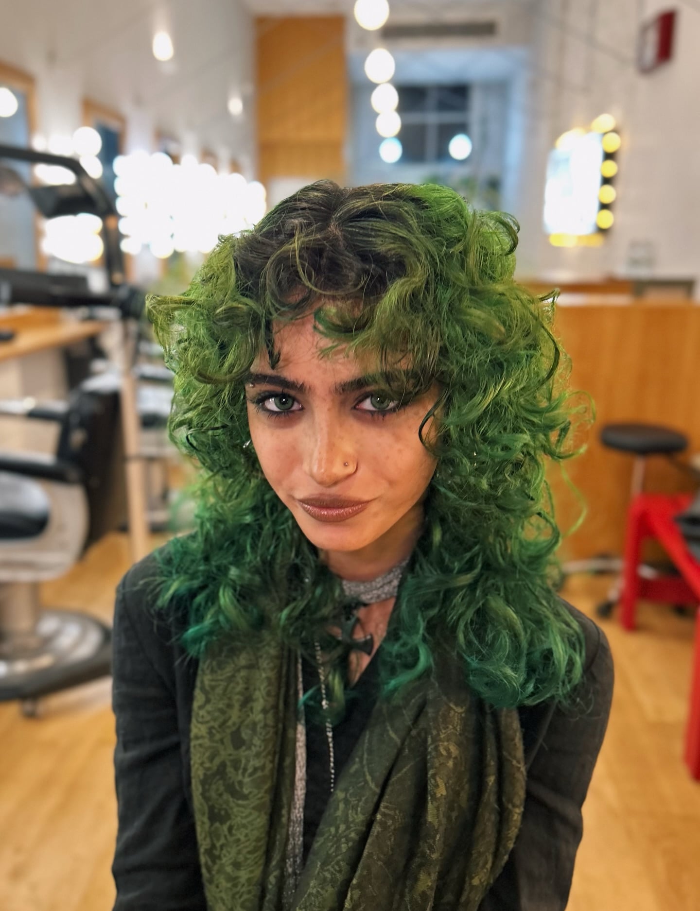 Green Semi-Permanent Over Dark Roots on a Layered Curly Wolf