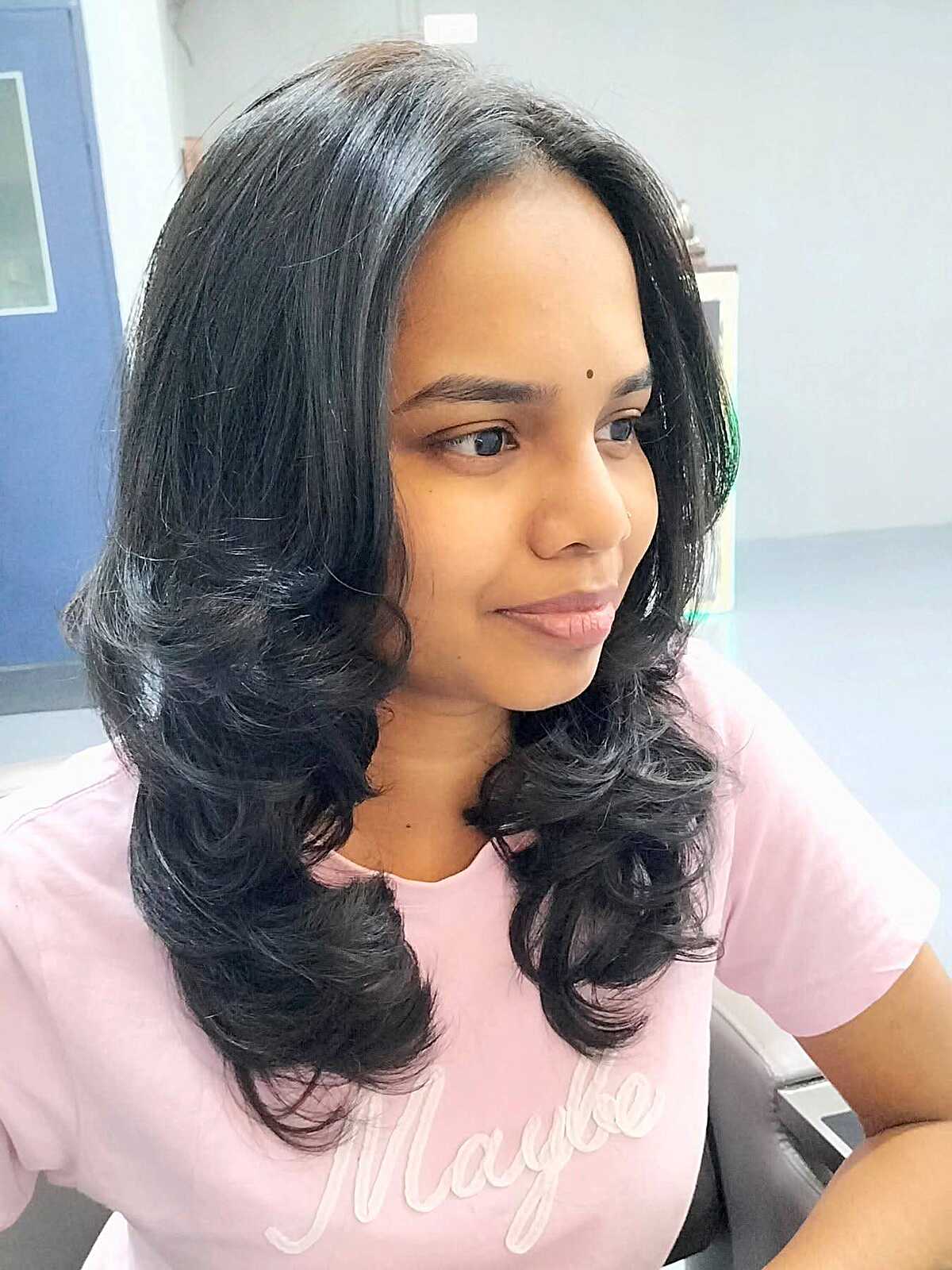 Jet black mid-length blowout with glamorous curls