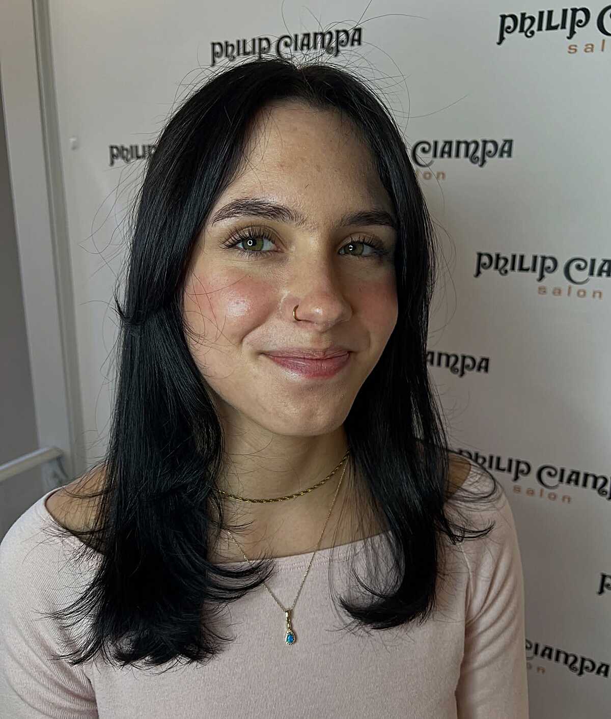 Jet black mid-length layered hair with deep side part