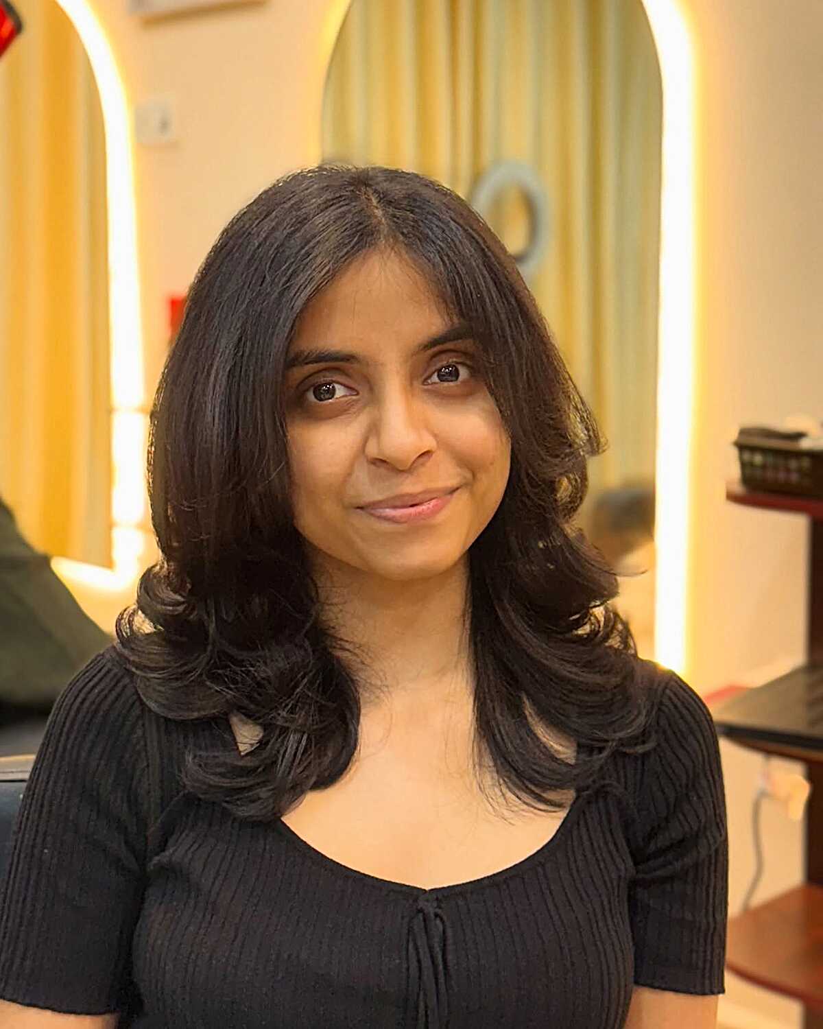 Black layered mid-length blowout with curled ends