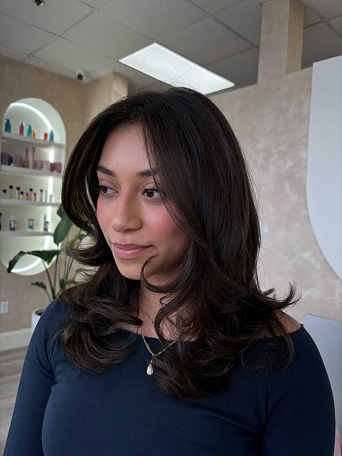 Dark brown mid-length hair with face-framing layers