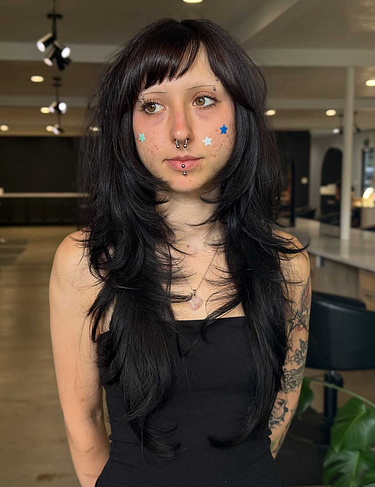 Long black textured layers with feathered baby bangs