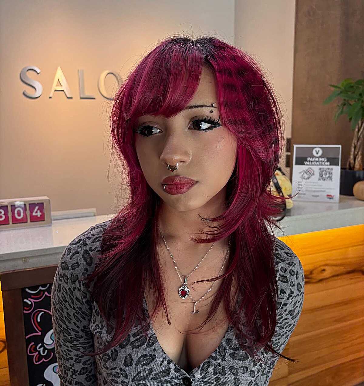 Magenta medium layered hair with micro bangs blending to sides