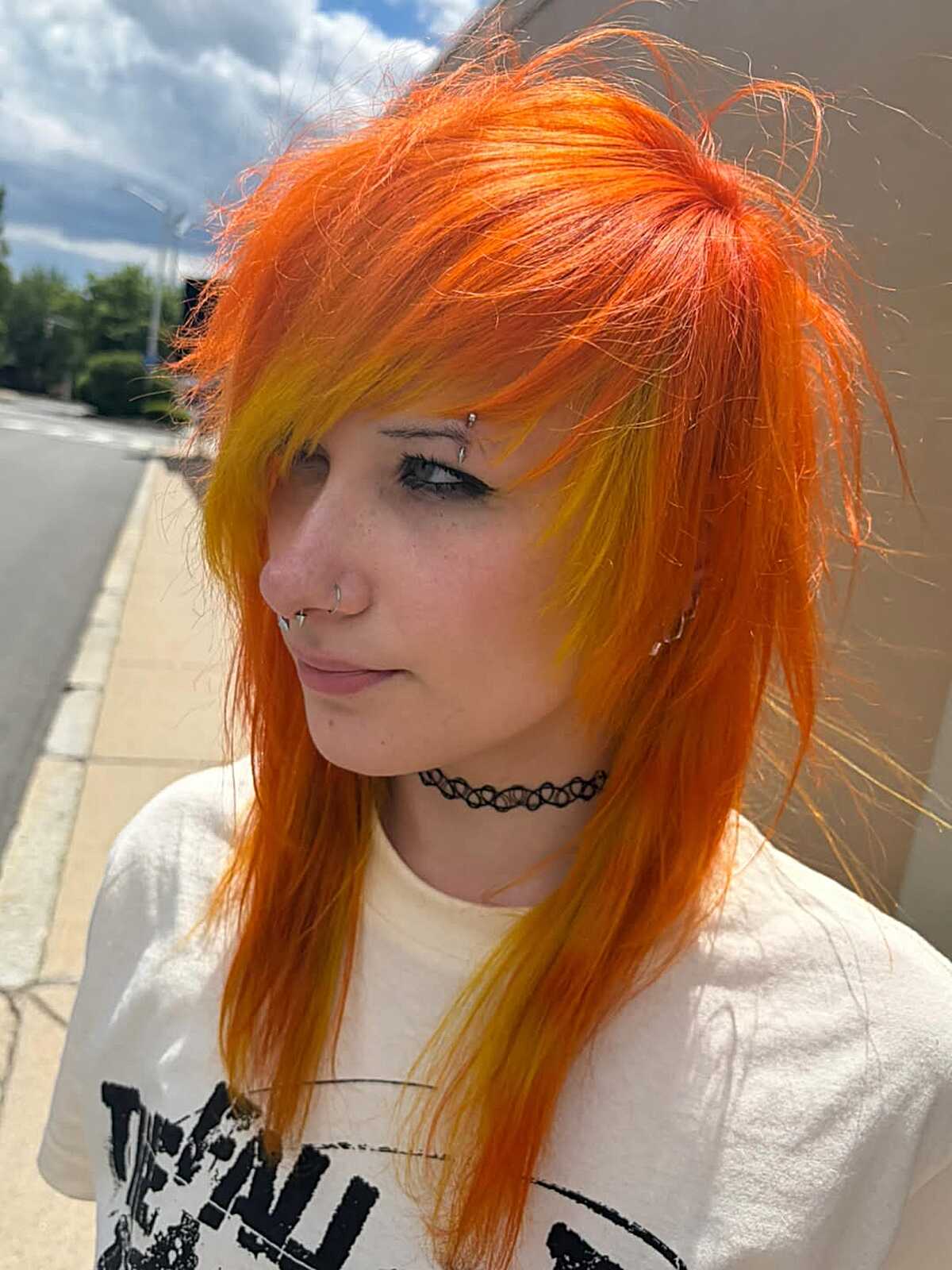 Bright orange and yellow layered hair with choppy side bangs