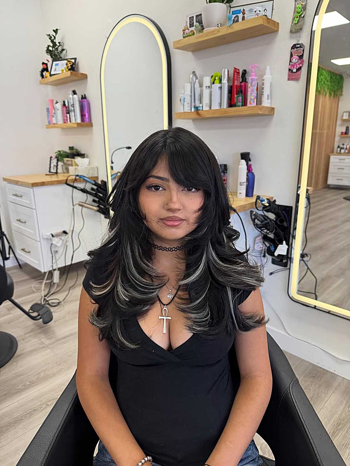 Black blowout with side bangs and silver highlights at tips