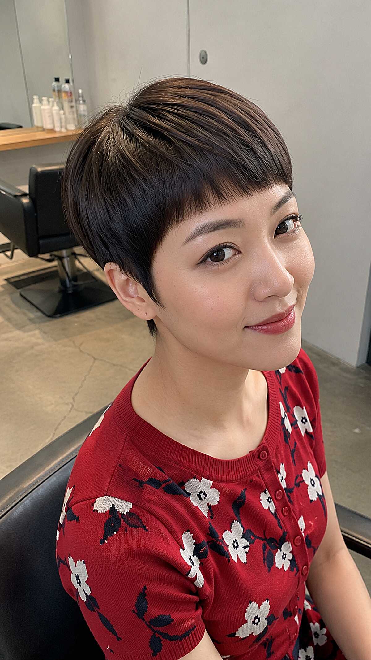 Sleek dark brunette micro pixie with side-swept bangs
