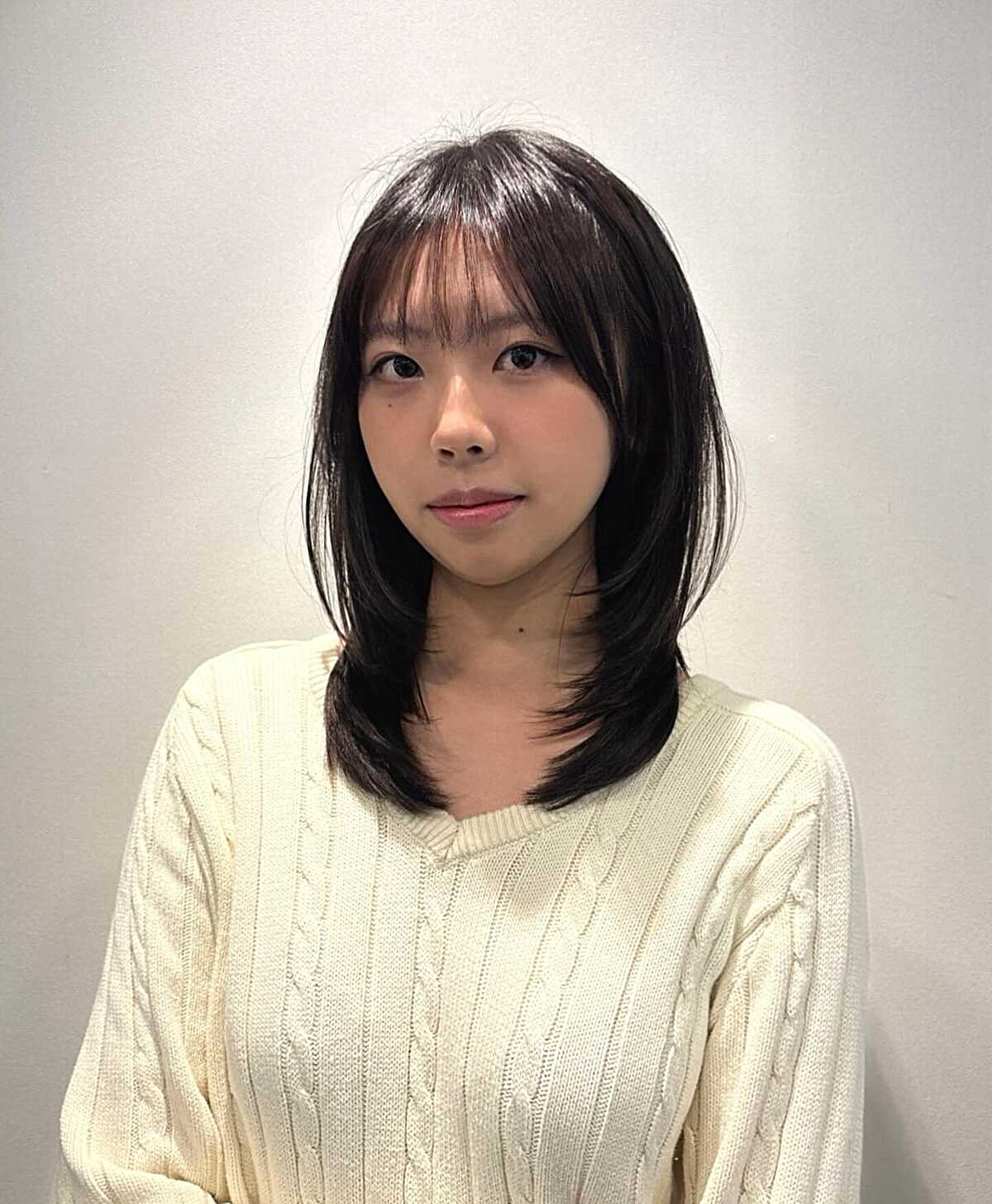Dark straight mid-length lob with thin see-through bangs