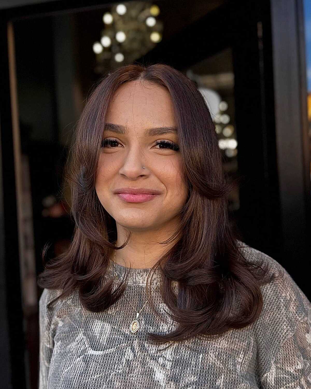 Plum-toned brunette bouncy mid-length blowout