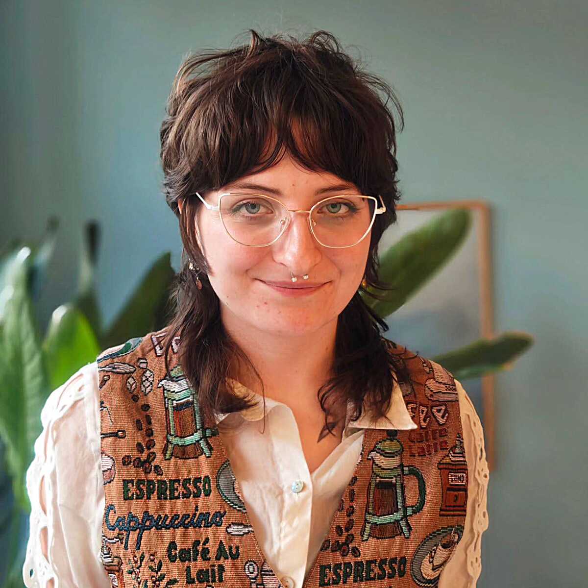Brunette shaggy mullet with choppy bangs and glasses