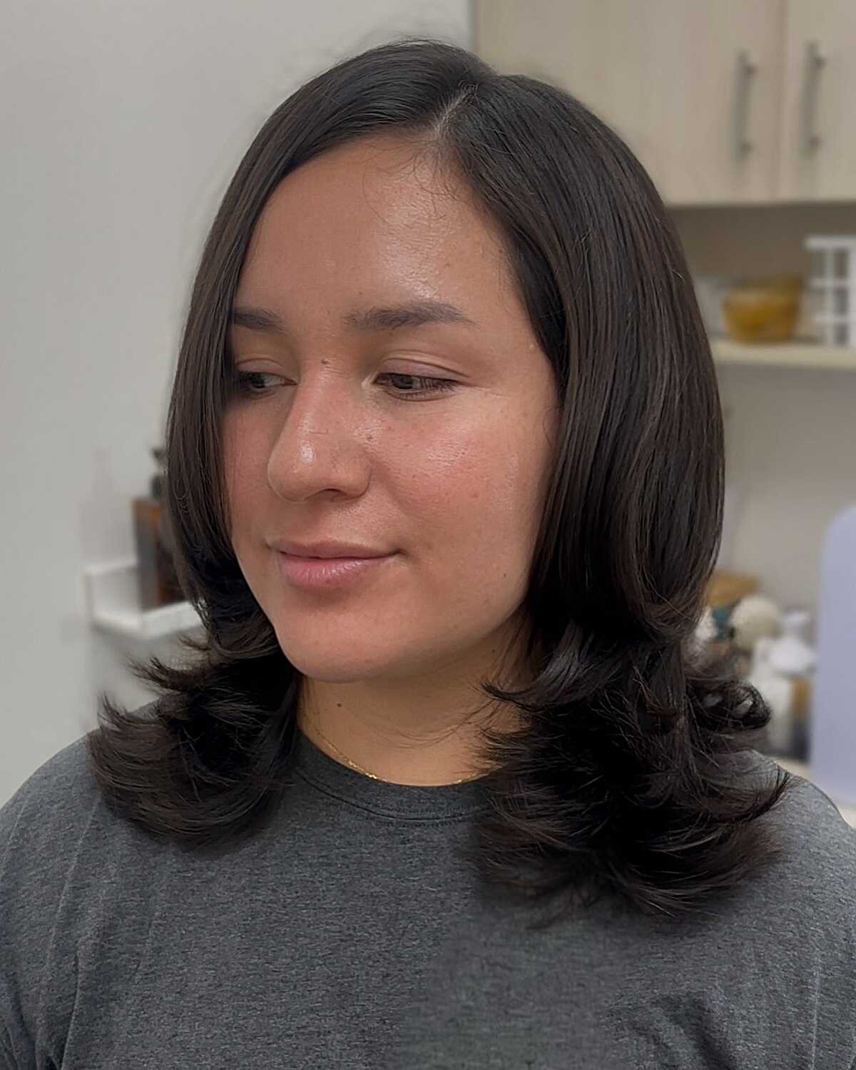 Dark brown mid-length blowout with curled ends