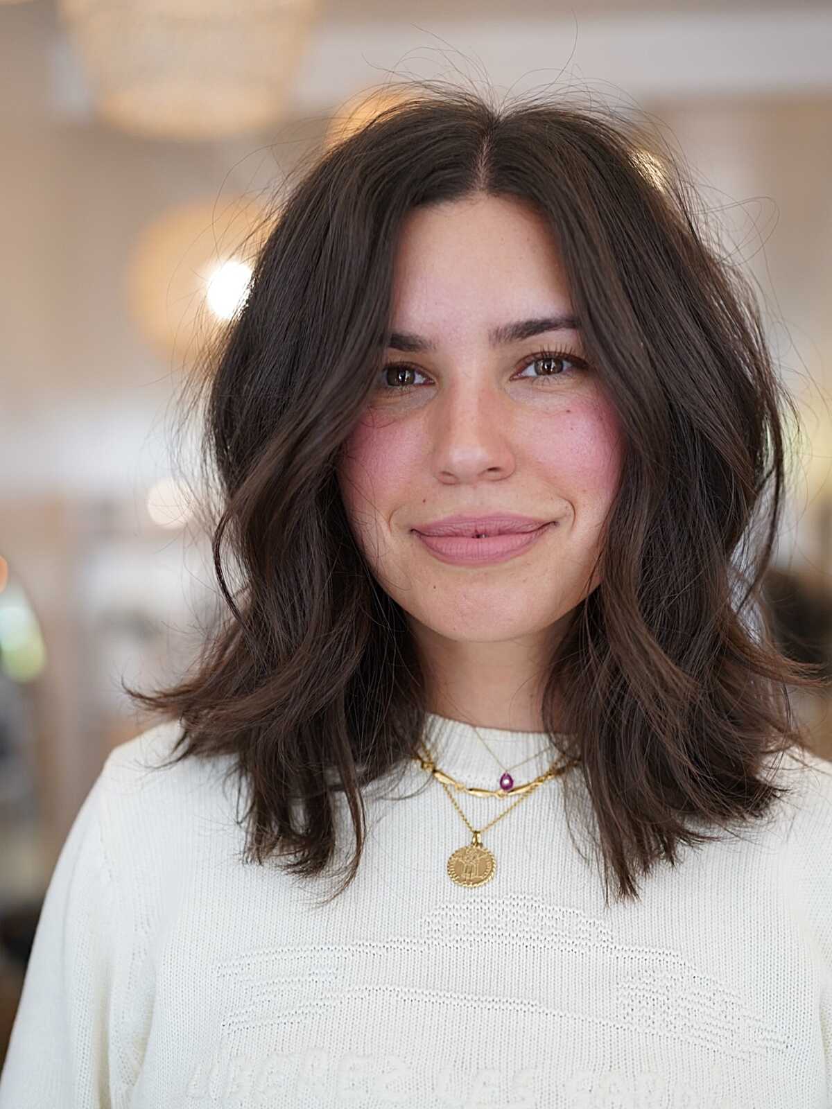 Brunette tousled lob with lived-in waves and texture