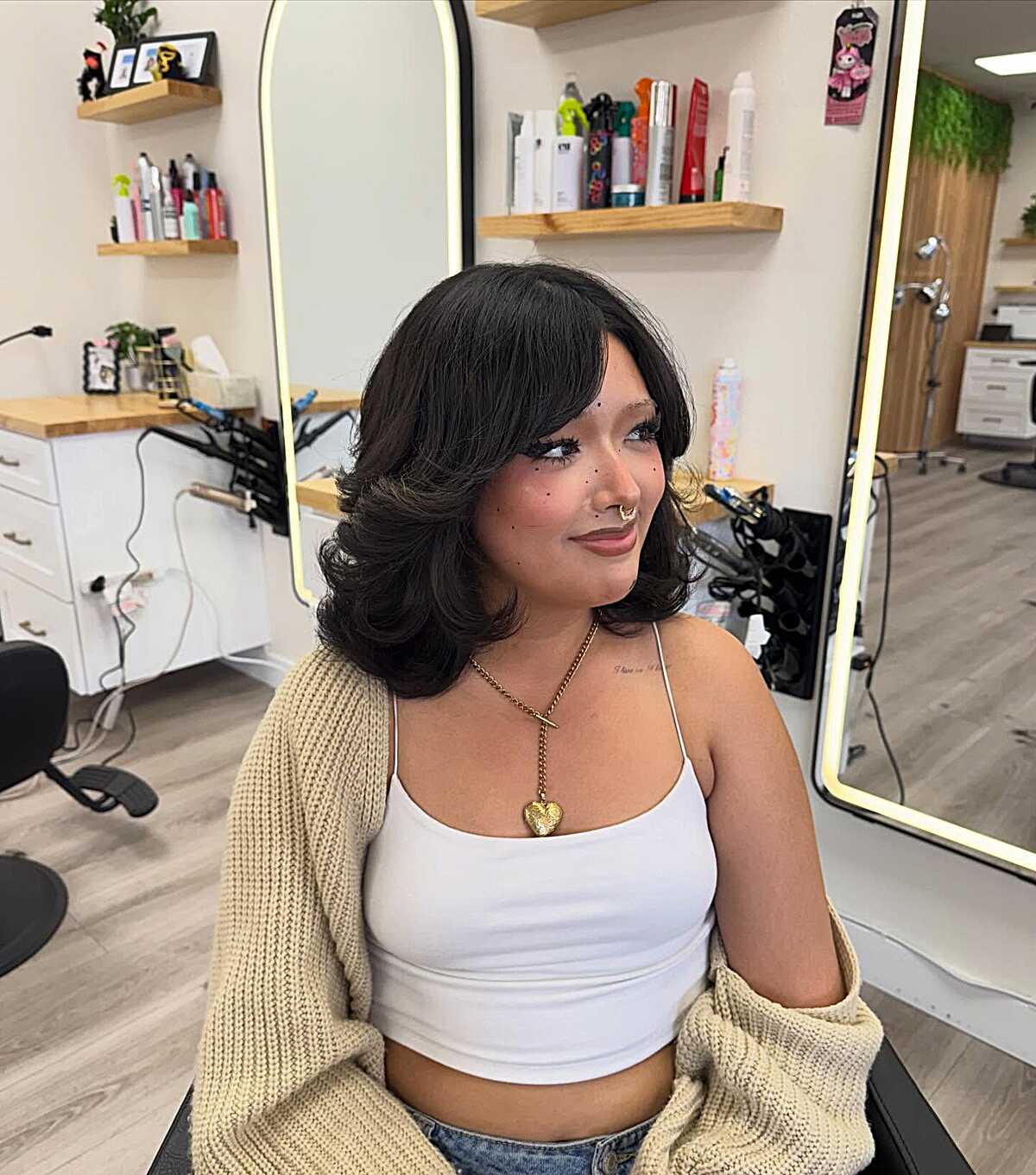 Dark chin-length bob with vintage curls and swoopy side bang