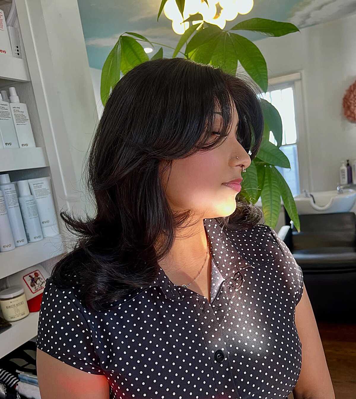 Black wavy mid-length blowout with volume at crown