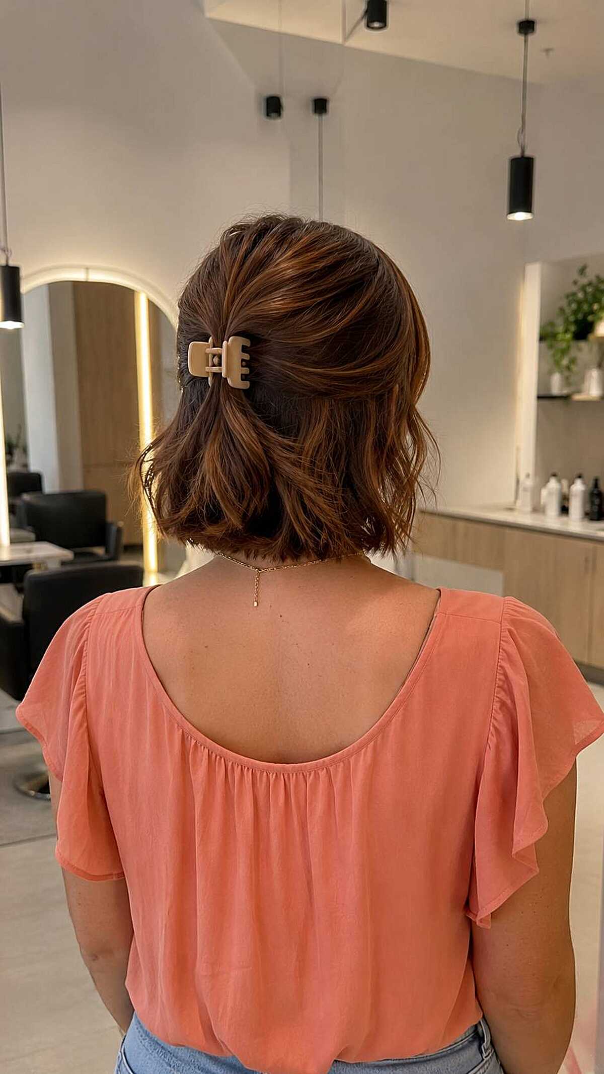 Back view of wavy bob in half-up with claw clip