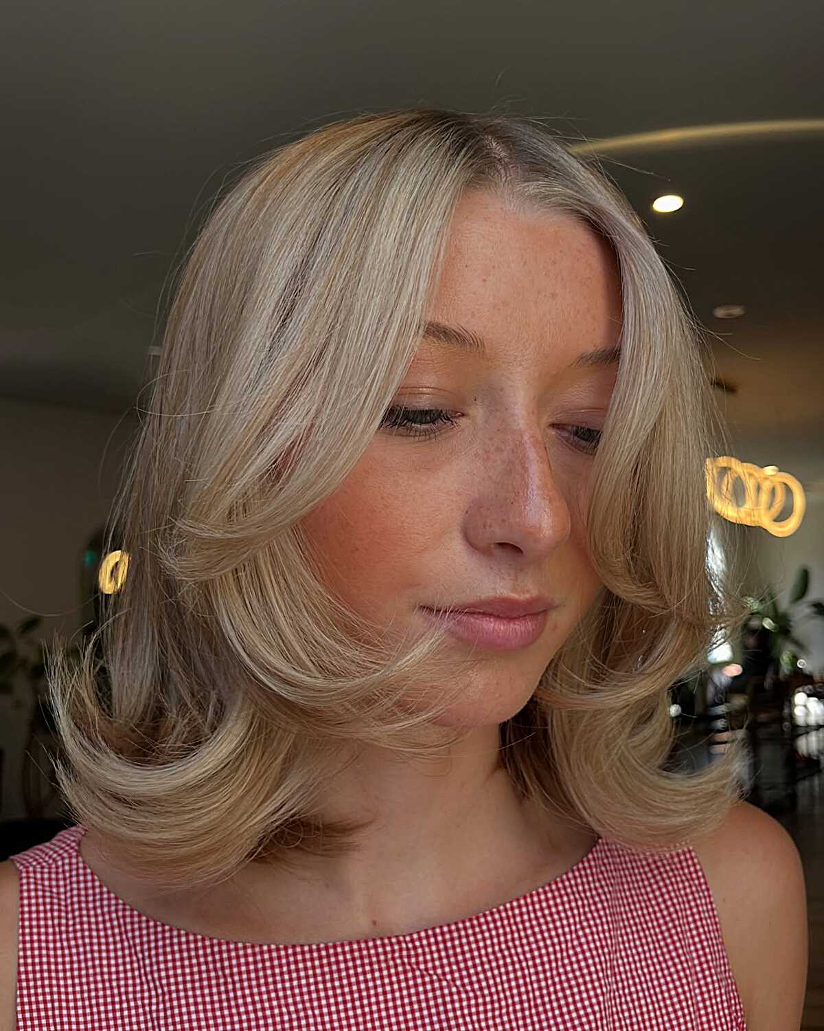 Ash blonde bob with bouncy flipped ends and center part