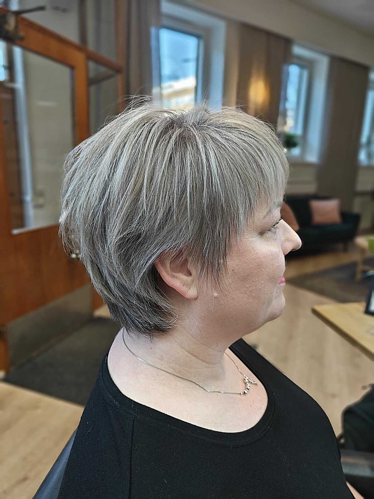 Ash gray tapered bixie with bangs in salon profile view