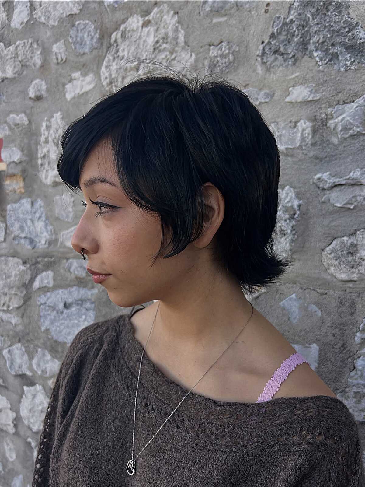 Short black pixie-bob with side fringe and layers