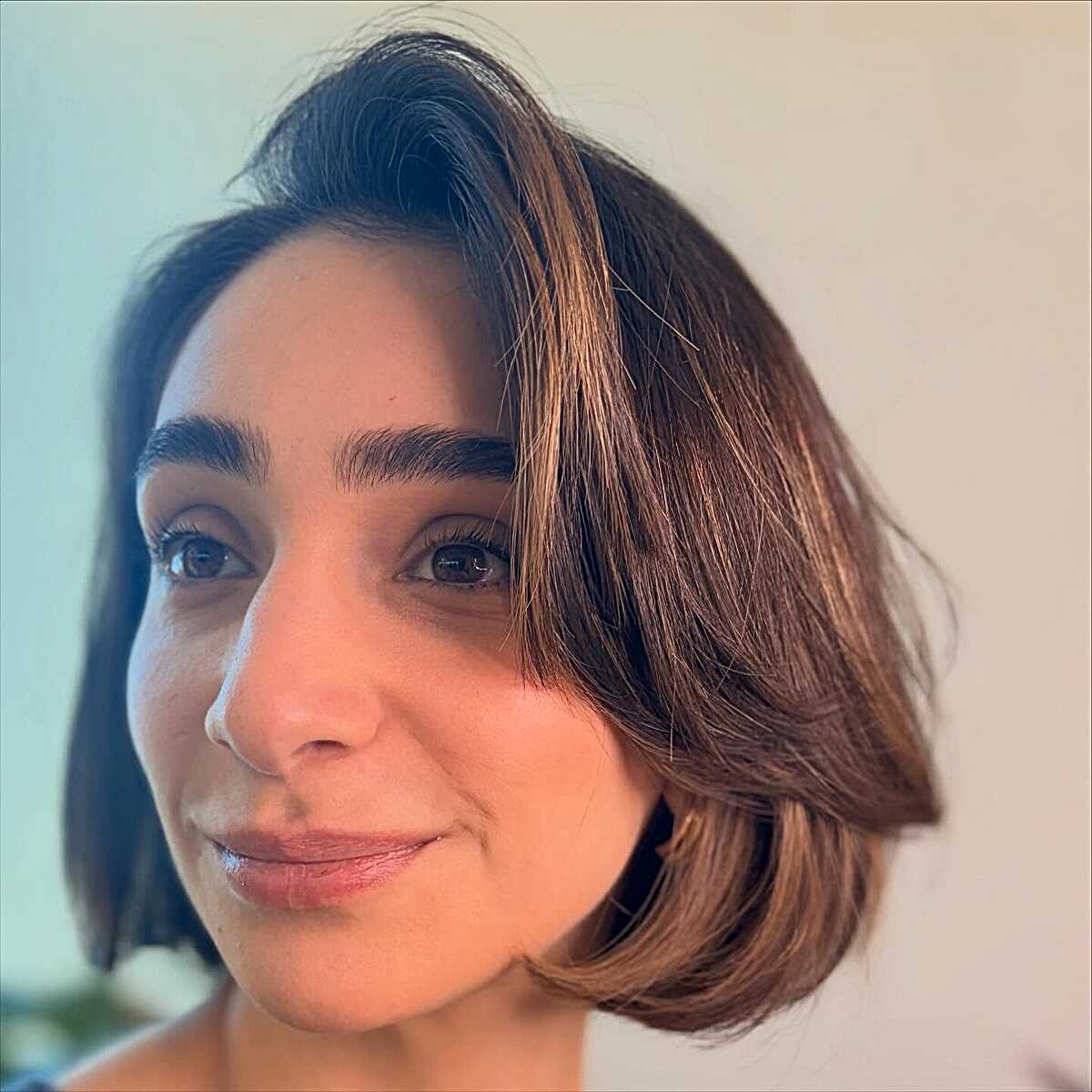 Brunette chin-length bob with flipped ends and deep part