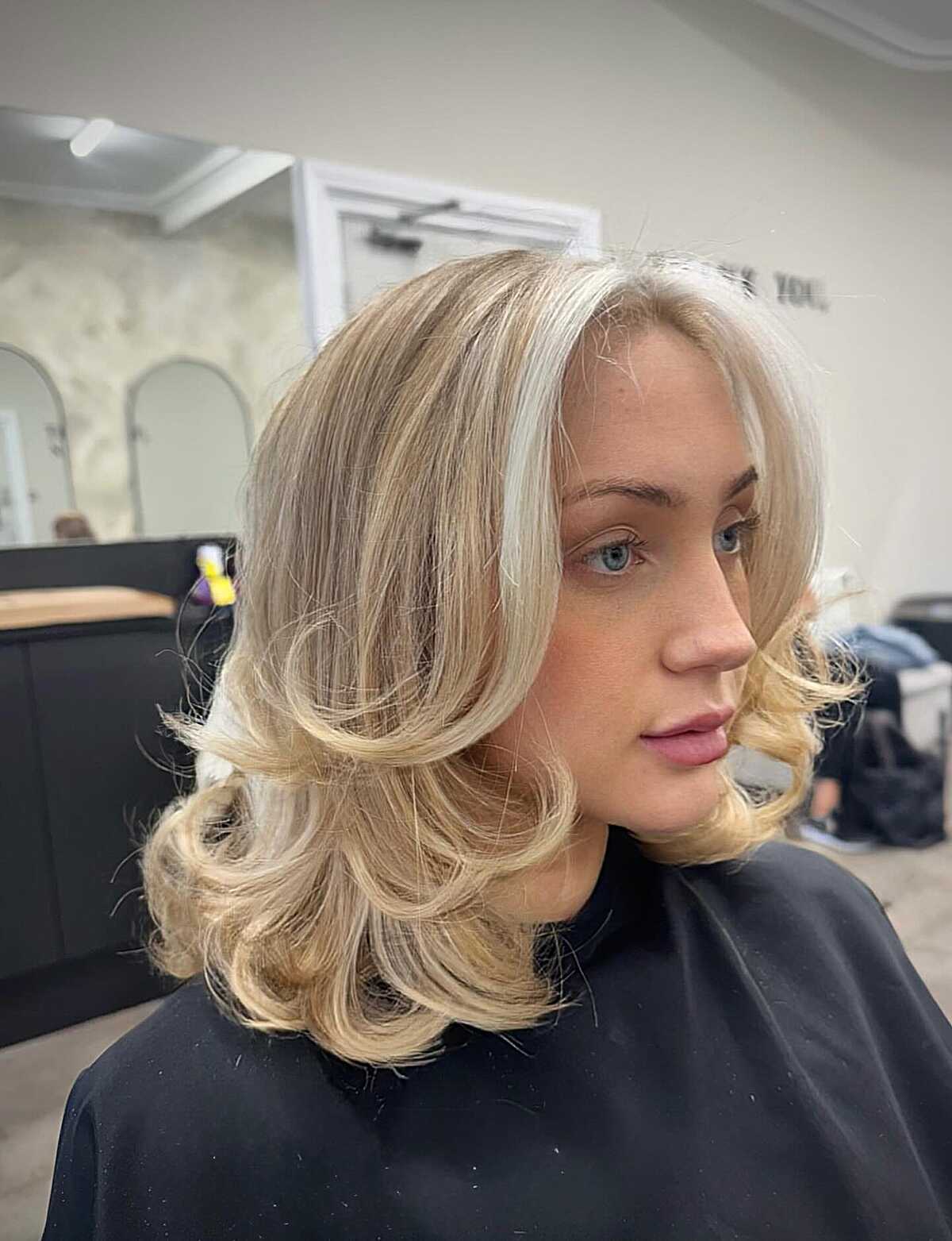 Champagne blonde lob with bouncy barrel curls