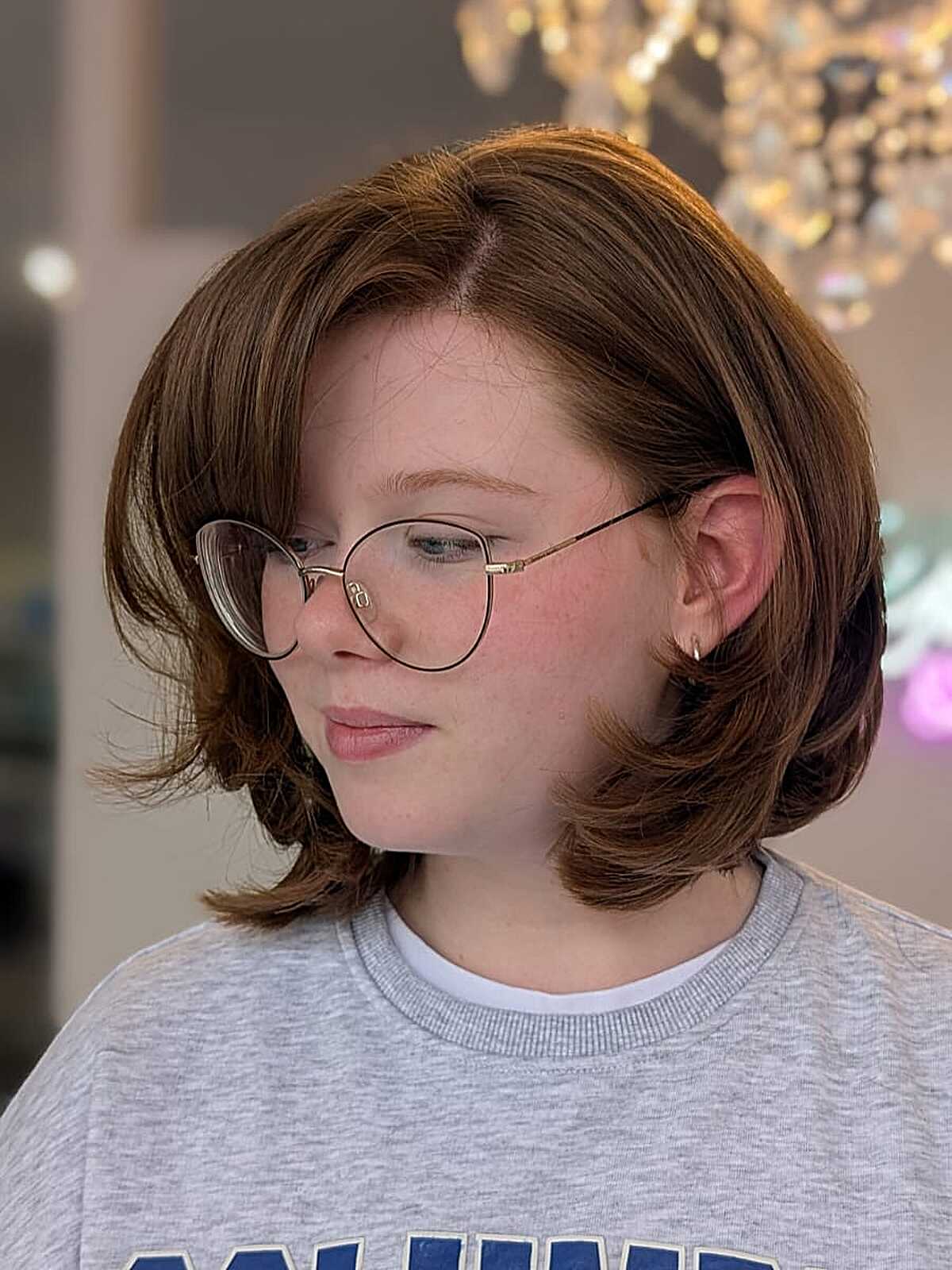 Chestnut brown baroque bob with flipped ends and glasses