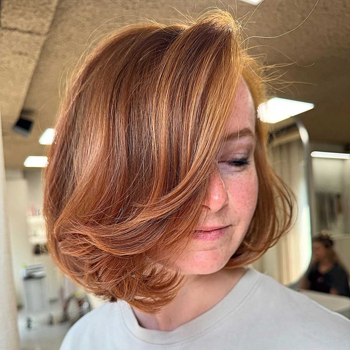 Copper red layered bob with voluminous flipped ends