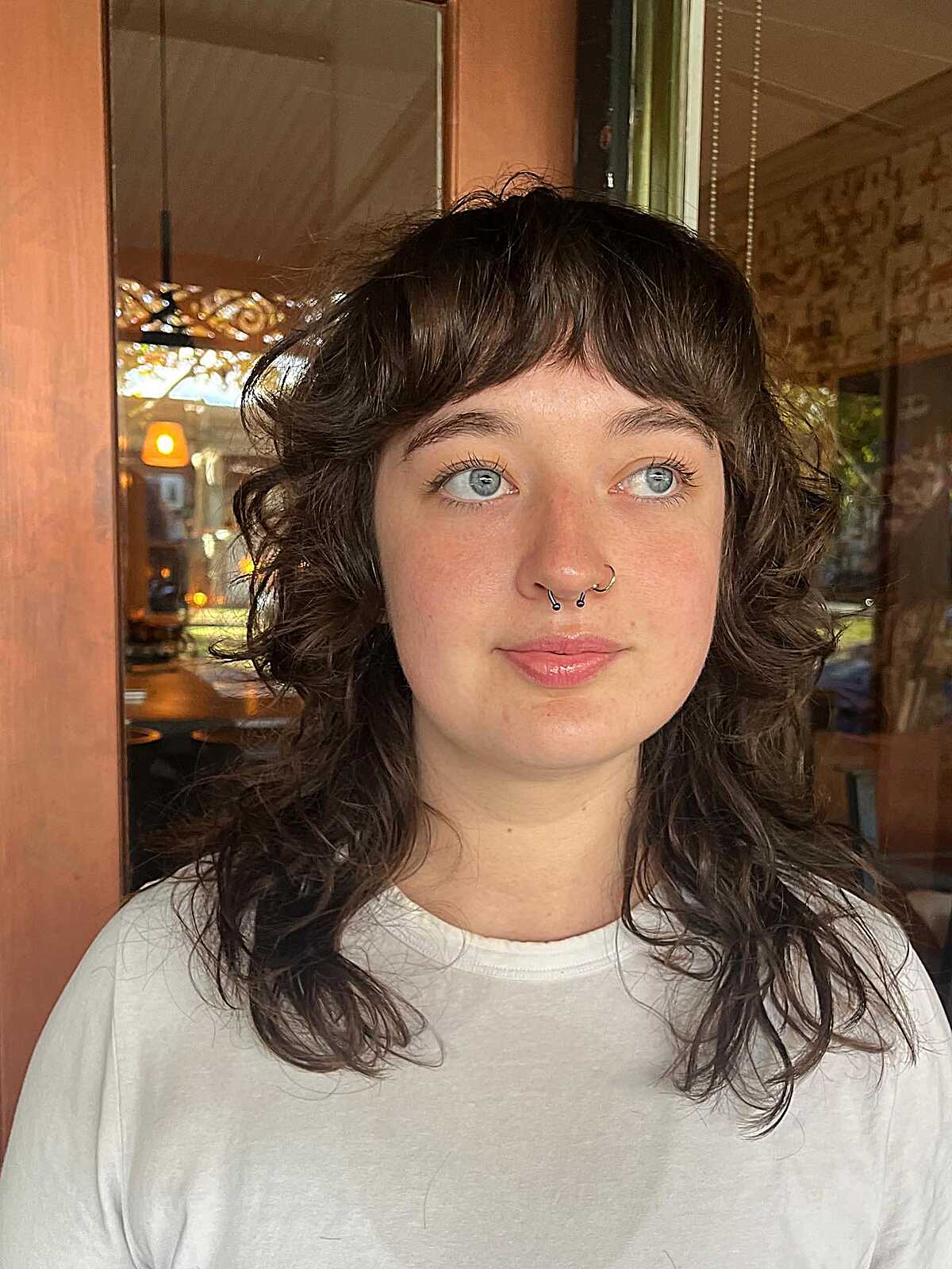 Shoulder-length curly shag with short bangs and texture