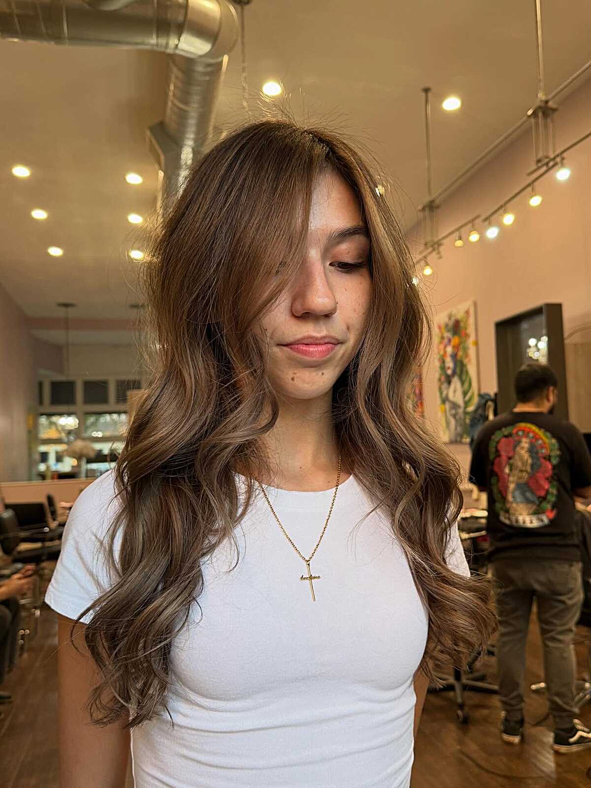 Long brunette waves with curtain bangs and soft layers