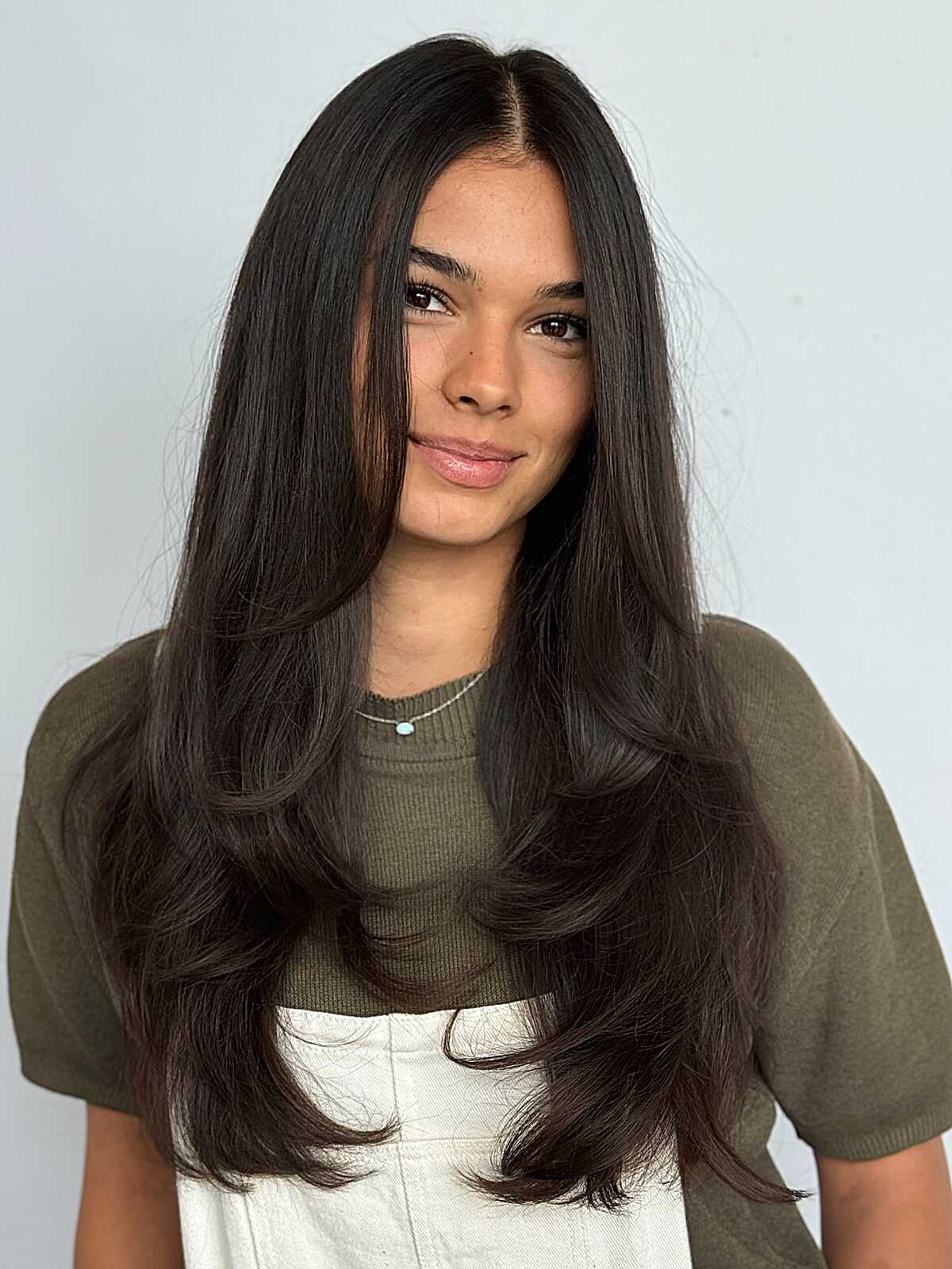 Long dark hair with voluminous face-framing layers