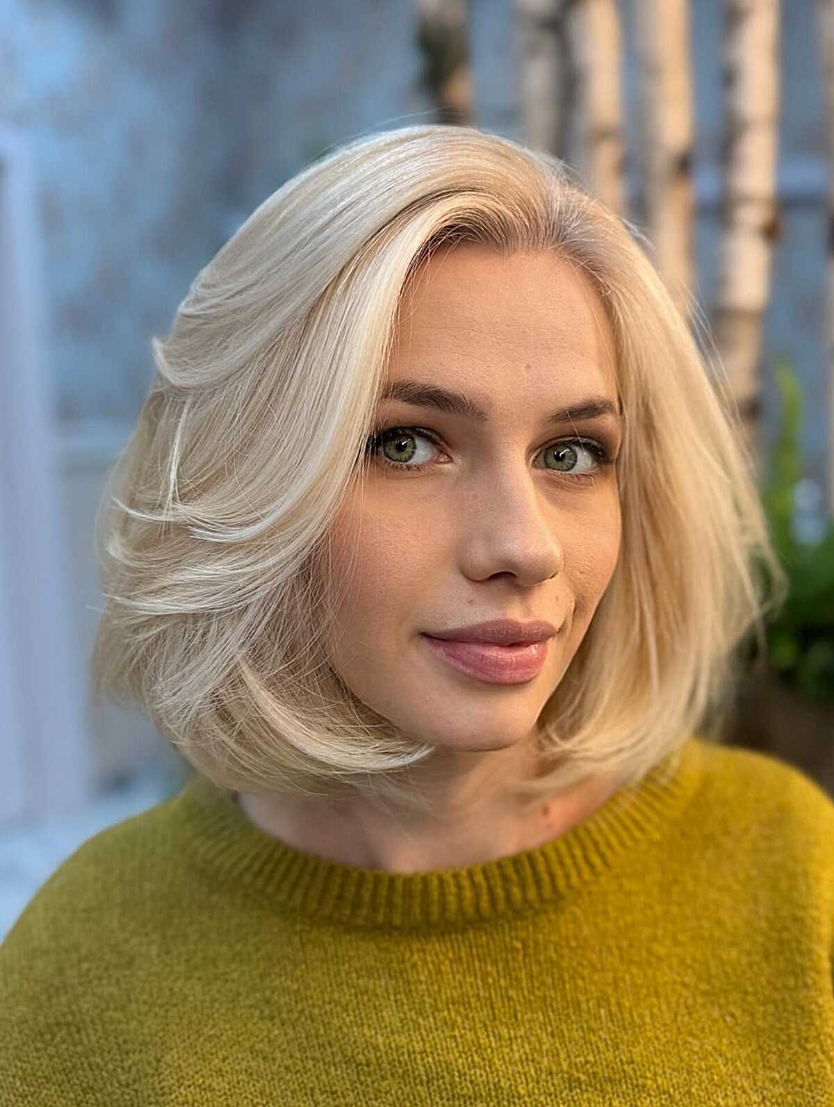 Platinum blonde bob with soft inward-curving ends