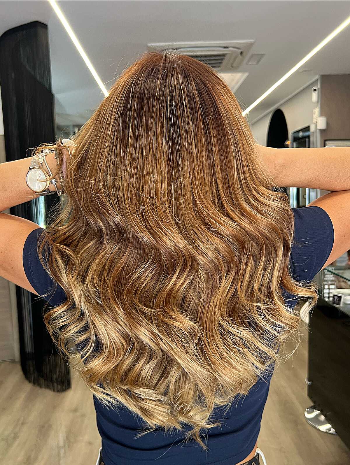 Long wavy hair with warm caramel and copper tones