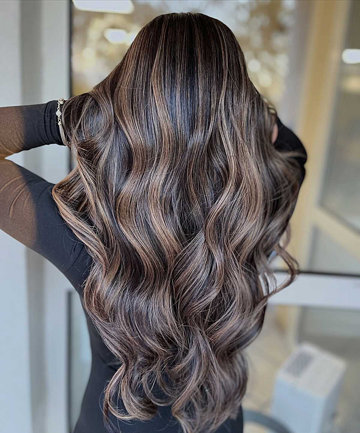 Long wavy dark brunette with cool-toned highlights