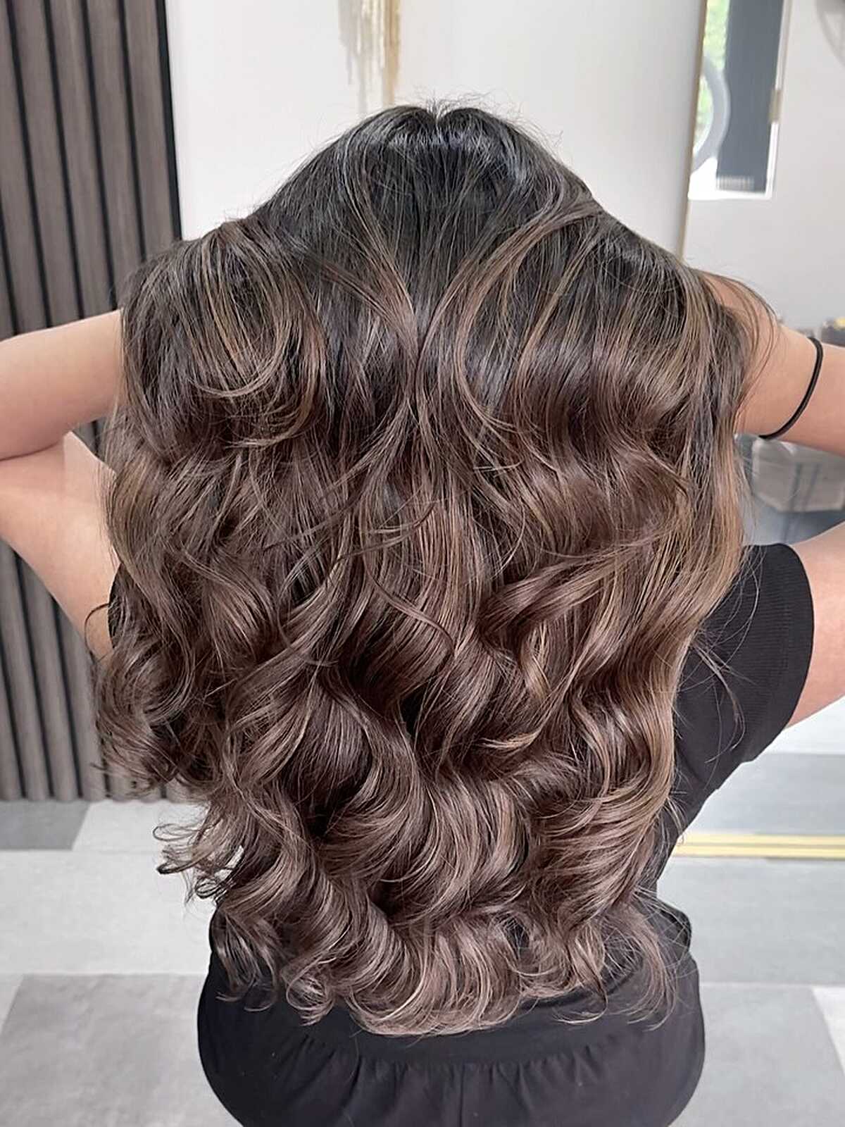 Dark brunette with glossy barrel curls and subtle lift