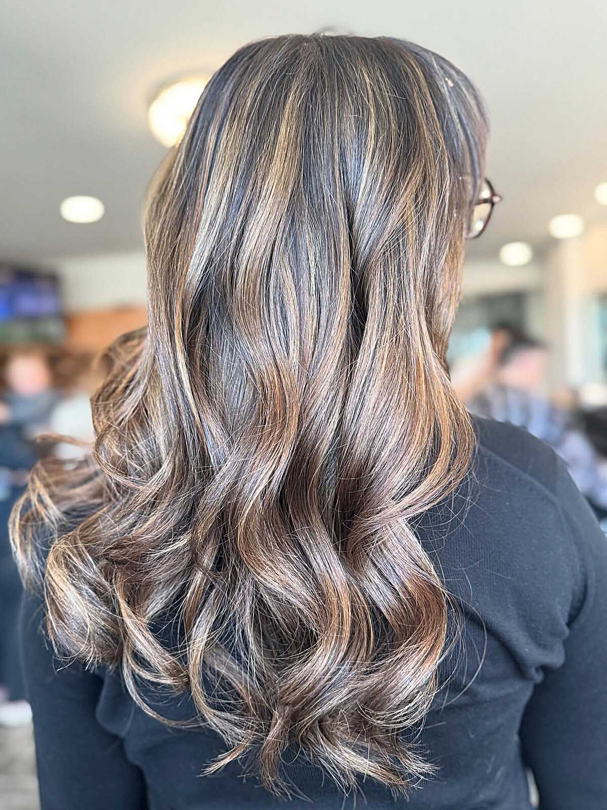 Brunette curls with dimensional caramel ribbon highlights