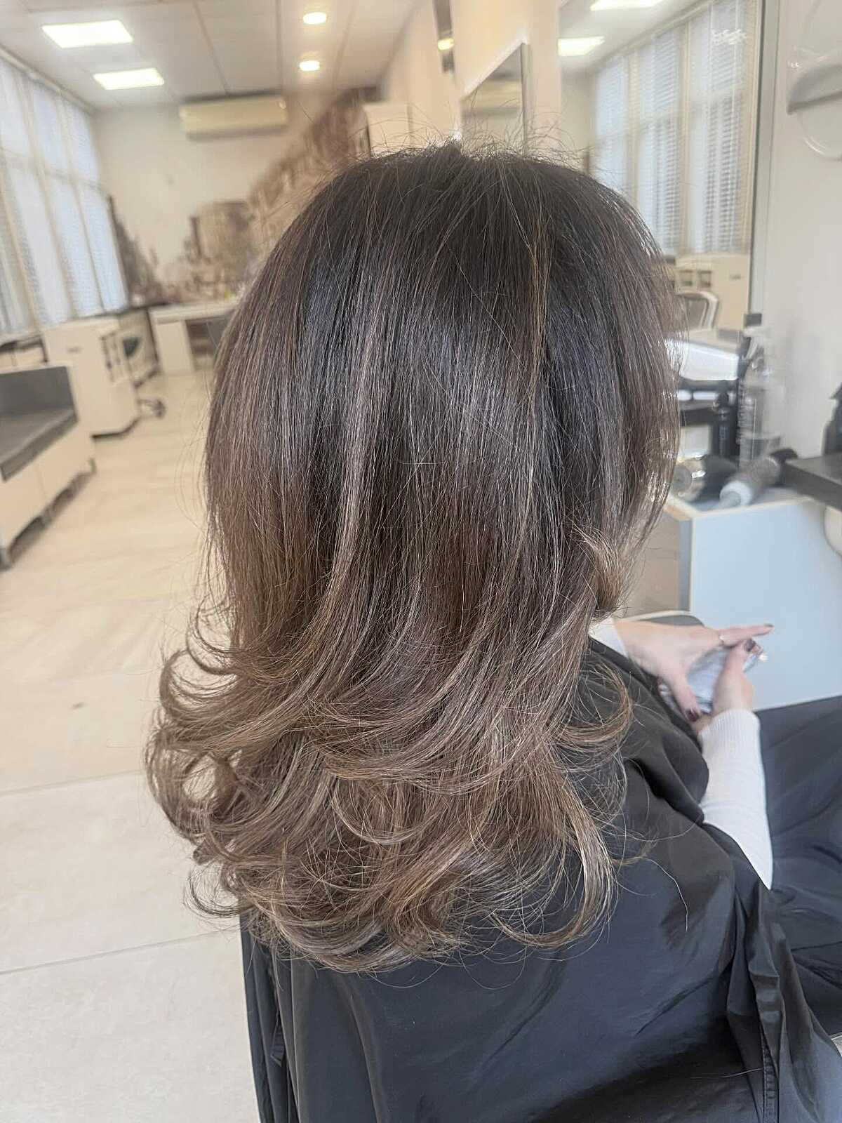 Medium layered brunette with vintage rolled curls