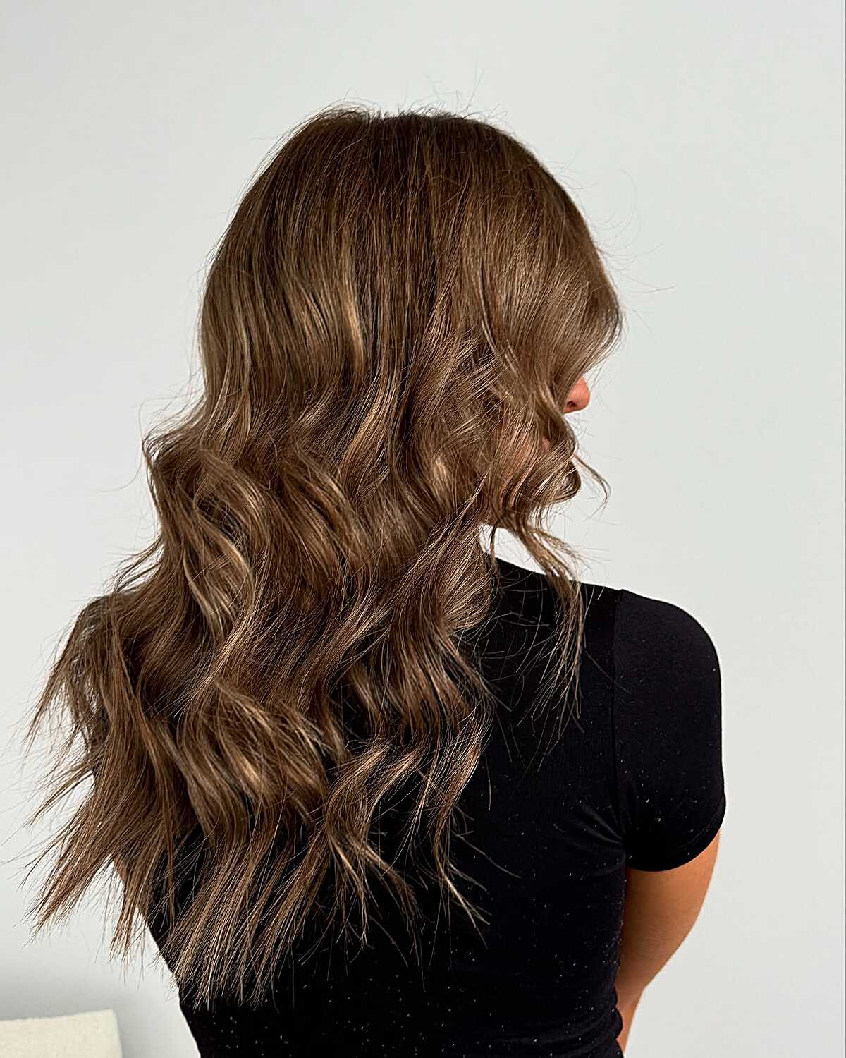 Tousled long brunette waves with lived-in latte color