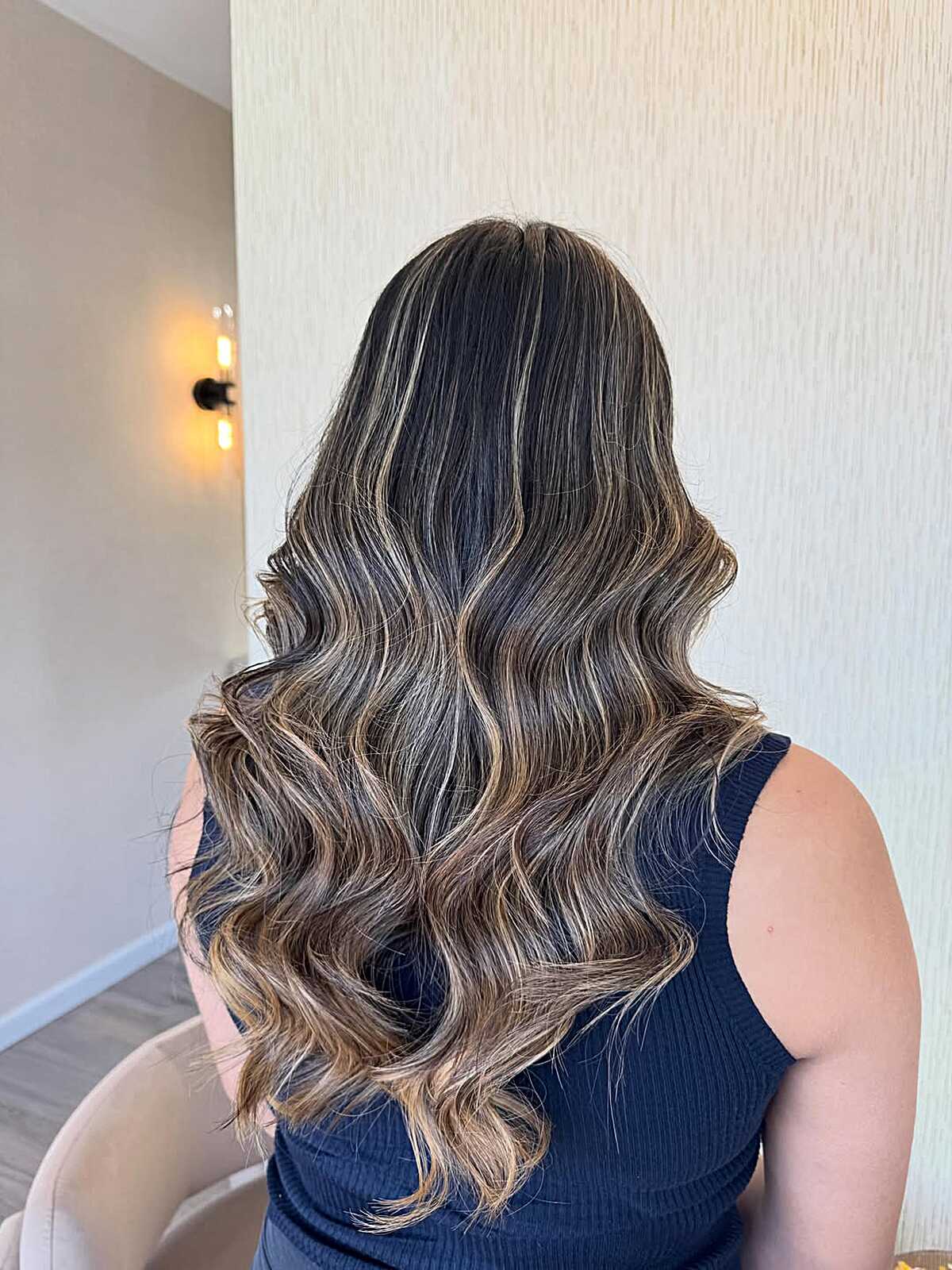Long wavy brunette with smoky bold highlights