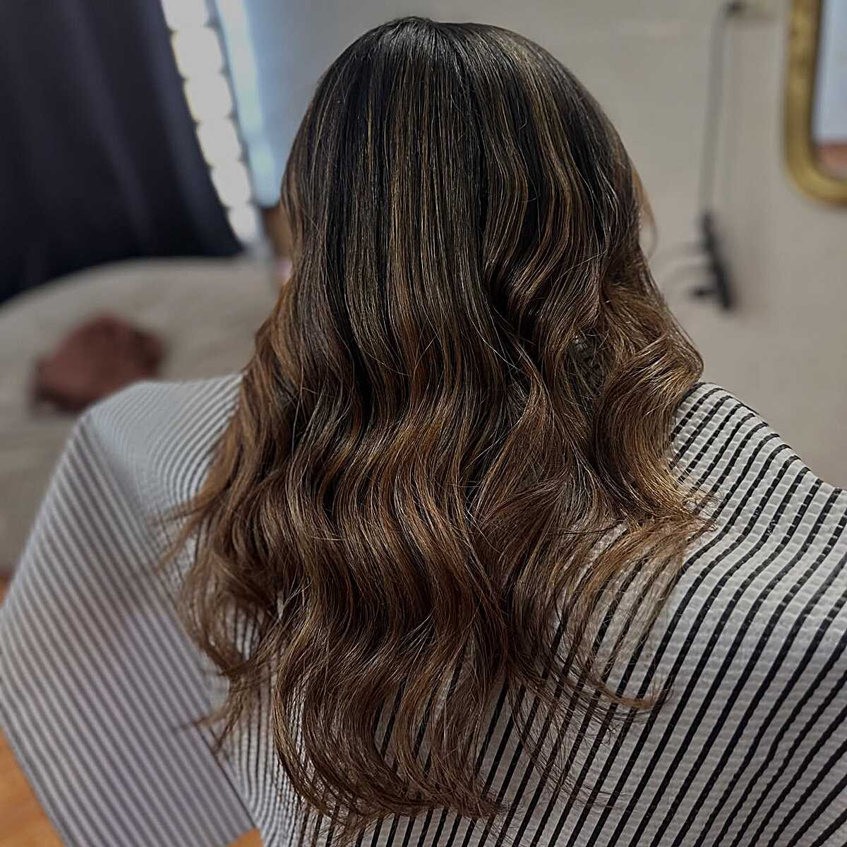 Shoulder-length wavy brunette with toasted almond tones