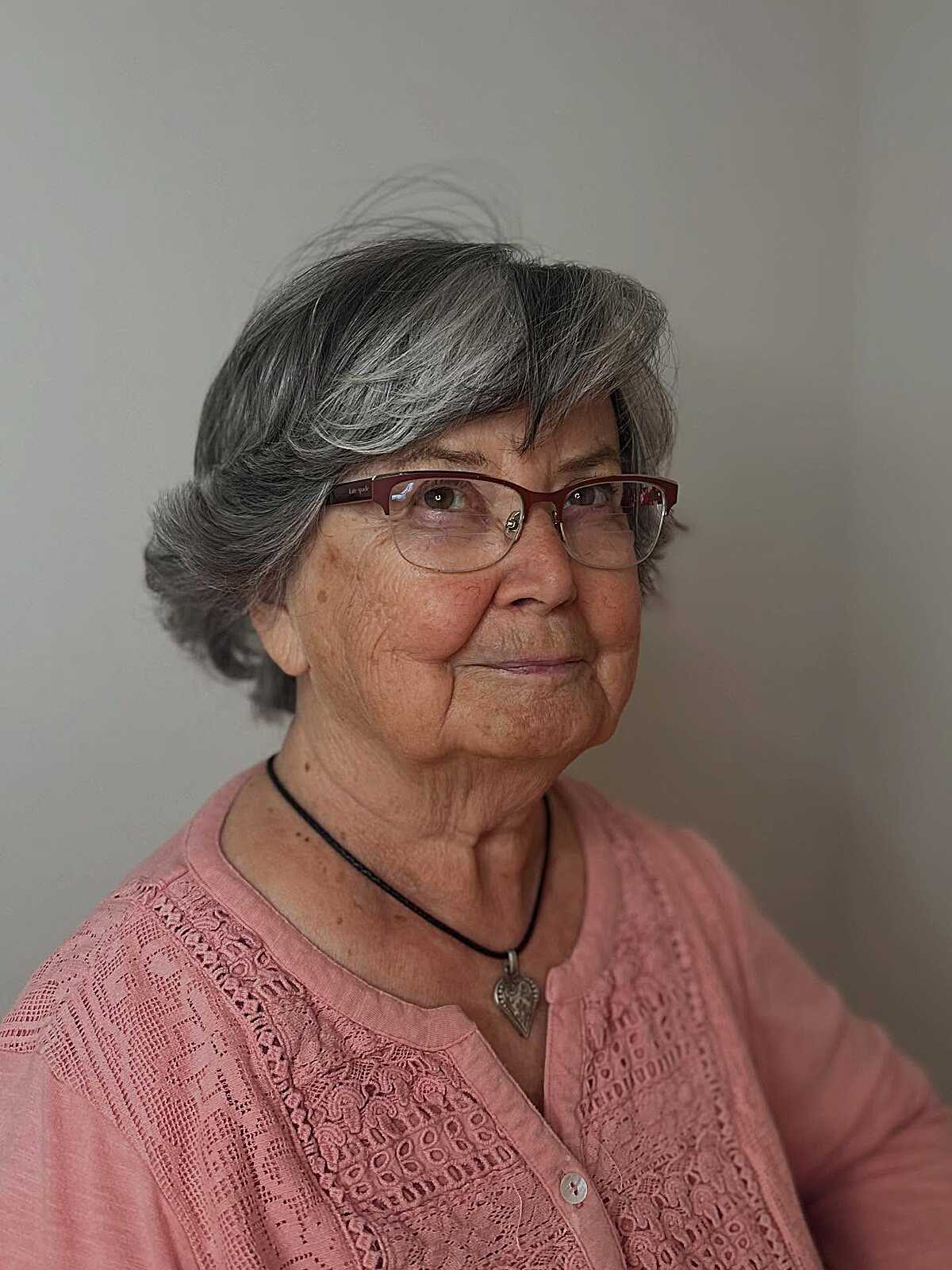 Natural gray bixie with soft waves and red glasses