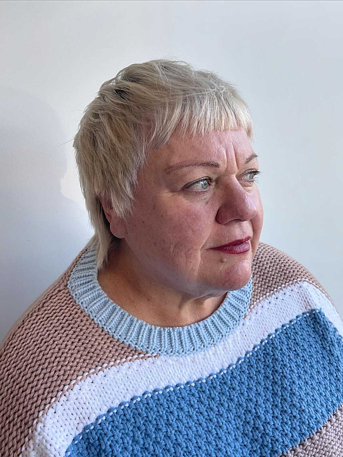 Platinum blonde piecey bixie on plus-size older woman