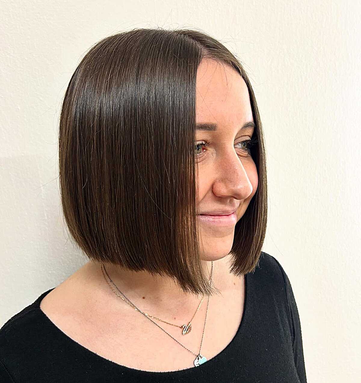 Sleek chin-length brunette bob with sharp blunt ends
