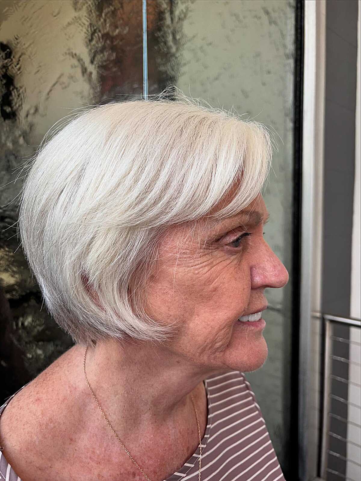 Pure white rounded bixie with soft bangs in profile